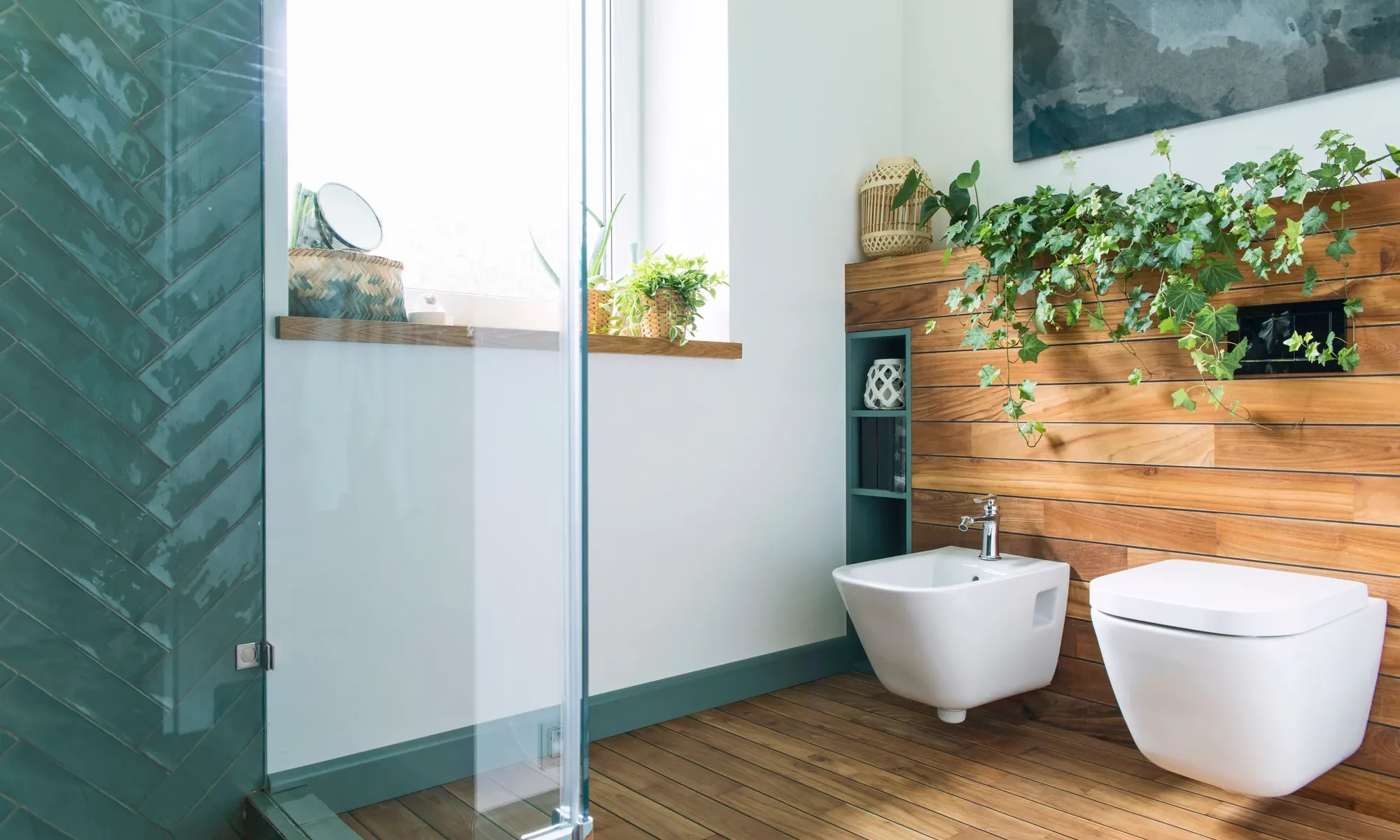 Green tiled shower, wall-hung toilet and bidet on a wood plank wall, bathroom remodeling